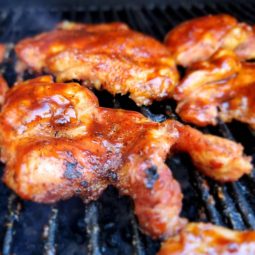Chicken on grill with bbq sauce