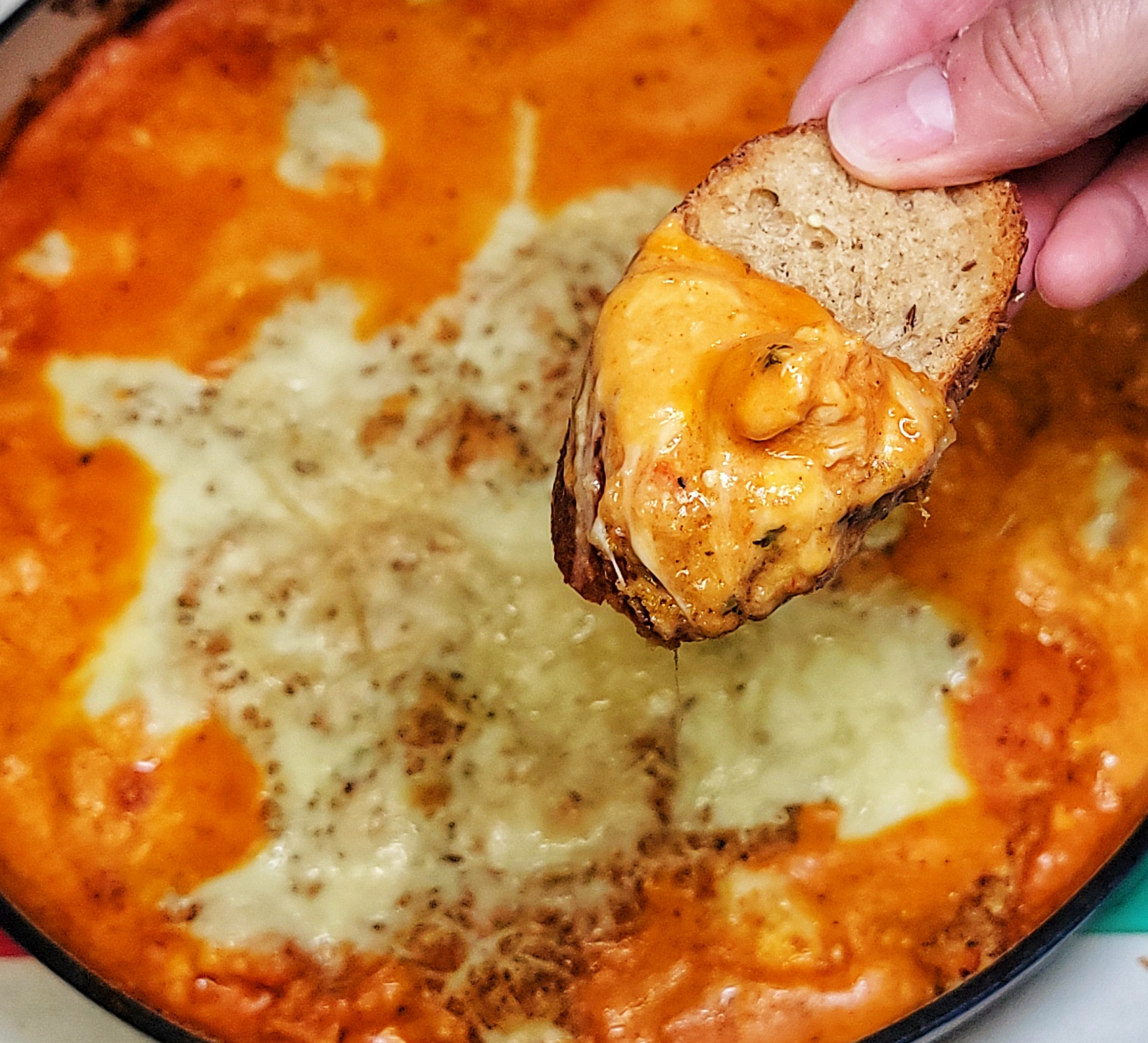 close up of chicken parm dip on bread