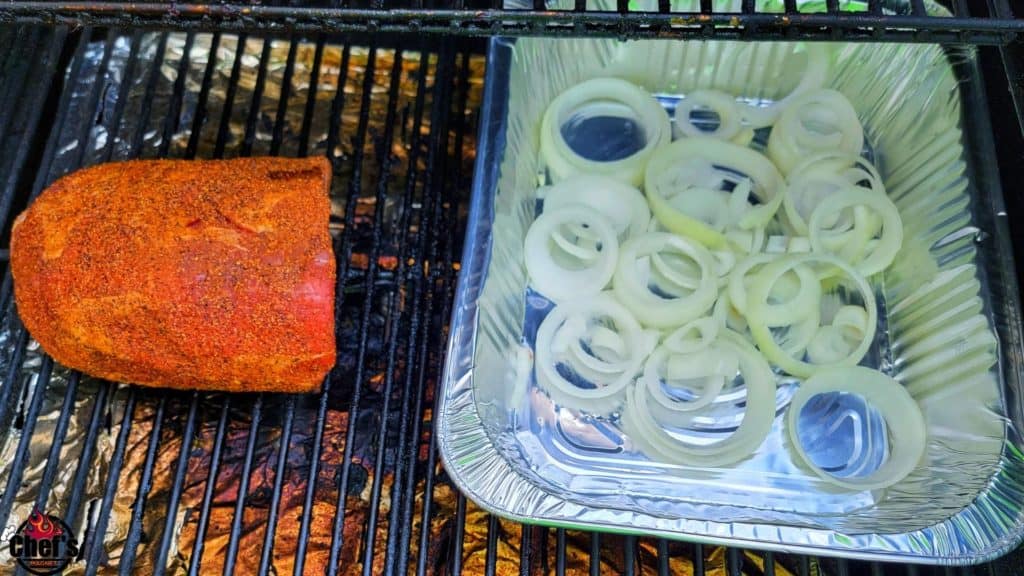 Roast on the grill grates and aluminum pan with sliced onions 