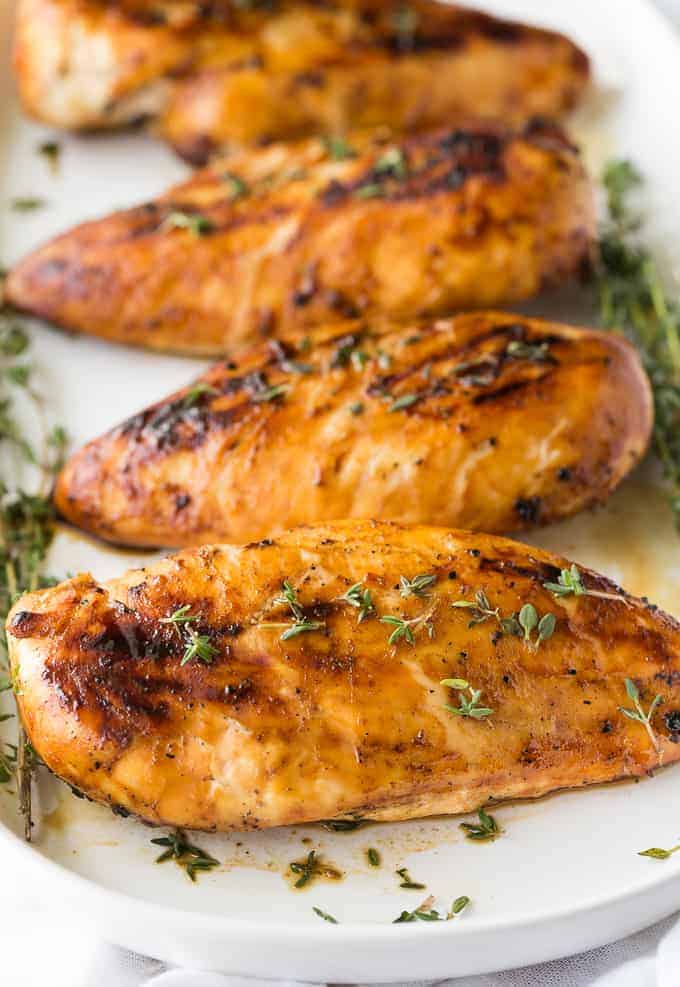 Cooked chicken breasts with pieces of thyme 