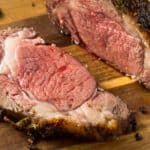 Sliced prime rib roast on cutting board