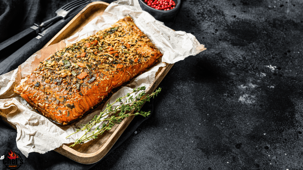 Smoked salmon sitting on tin foil and metal pan